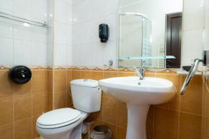 a bathroom with a toilet and a sink at Motel Delorean in Săcele +19 photos