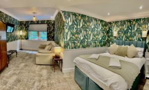 a bedroom with a bed and a living room at Falls of Lora Hotel in Oban
