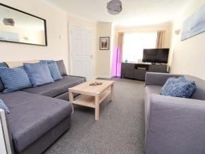a living room with two couches and a coffee table at The Beach Escape in Prestatyn