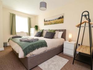 a bedroom with a large bed and a window at The Beach Escape in Prestatyn
