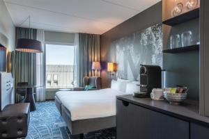 a hotel room with a bed and a large window at Radisson Blu Metropol Helsingborg in Helsingborg +241 photos