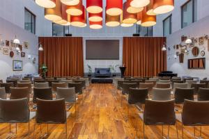 a conference room with chairs and a podium at Radisson Blu Metropol Helsingborg in Helsingborg