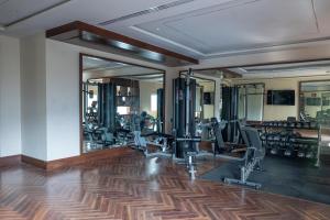 a gym with treadmills and ellipticals and mirrors at Radisson Blu Resort Kumbhalgarh in Kumbhalgarh
