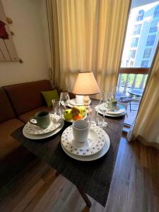 a table with plates of food and drinks on it at Cascadas, Studio apartment with a pool view in Sunny Beach