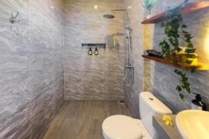 a bathroom with a shower and a toilet at Damara Ubud in Ubud