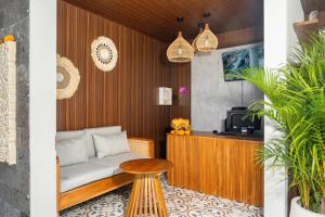 a living room with a couch and a table at Damara Ubud in Ubud +21 photos