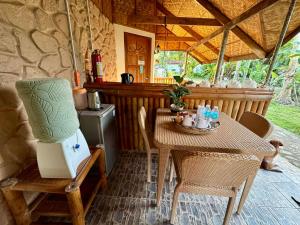 a table with a laptop on it in a kitchen at Bananaland Cottages in Panglao Island +58 photos