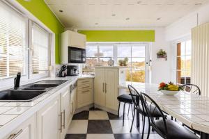a kitchen with green walls and a table with chairs at La Villa des Hauts Chênes in Bouillon +34 photos