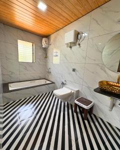 a bathroom with a black and white striped floor at Private Rooms In Riverstone in Karjat
