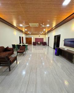a large living room with couches and a flat screen tv at Private Rooms In Riverstone in Karjat