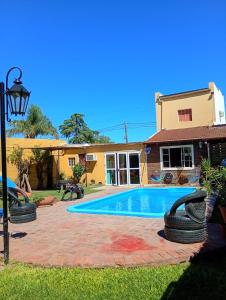 a house with a swimming pool with tires around it at Posada del Baradero in Baradero