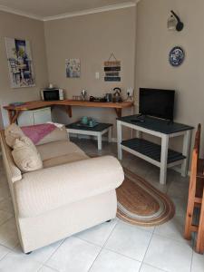 a living room with a couch and a desk at 36 Mount Road Guesthouse and Self Catering in Port Elizabeth