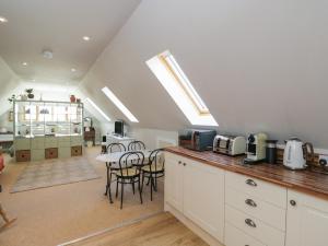 a kitchen with a counter and a table and chairs at The Hideaway Loft in Chippenham