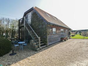 a small house with a staircase next to a yard at The Hideaway Loft in Chippenham
