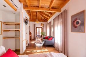 a living room with a couch and a chair at Casa de la Catedral in Granada