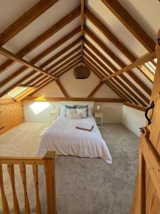 a bedroom with a bed in the attic at Wayeview Cottage on working Devon farm in Ipplepen