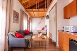a living room with a couch and a table at Casa de la Catedral in Granada