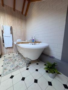 a bathroom with a white tub and a sink at Wayeview Cottage on working Devon farm in Ipplepen +46 photos
