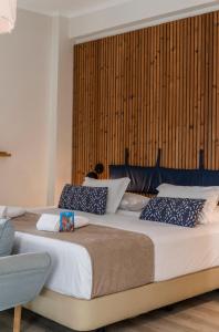 a bedroom with two beds with blue and white pillows at WOT Costa da Caparica Soul in Costa da Caparica