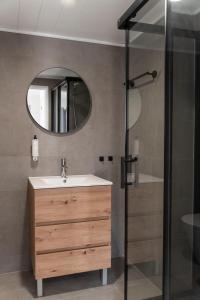 a bathroom with a sink and a mirror at WOT Costa da Caparica Soul in Costa da Caparica +62 photos