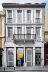 an apartment building with aania sign in front of it at Athenian Heart Suites in Athens