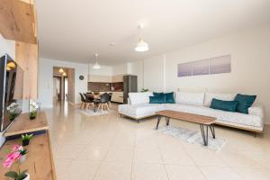a living room with a couch and a table at Theatre Home Aegean View in Nea Moudania