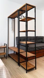 a black bunk bed with wooden shelves in a room at Hermoso Studio Premium en Microcentro in Buenos Aires +5 photos