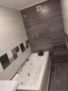 a bathroom with a bath tub with a sink at Пиргуля in General-Toshevo