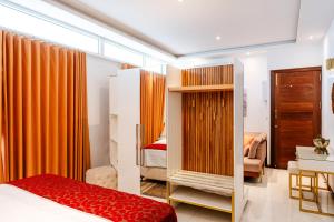 a bedroom with orange curtains and a bed and a desk at Senen Lanka in Kelaniya