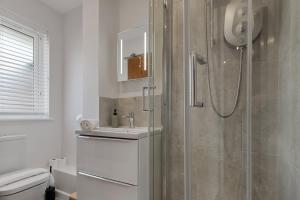 a bathroom with a shower and a sink at Urban Heights - 2 Bed Apartment - Short Stays UK Ltd in Exeter