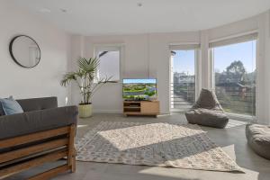 a living room with a couch and a television at Urban Heights - 2 Bed Apartment - Short Stays UK Ltd in Exeter