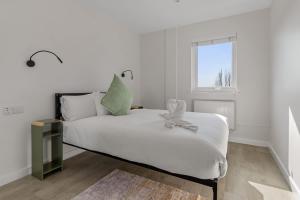 a white bedroom with a bed and a window at Urban Heights - 2 Bed Apartment - Short Stays UK Ltd in Exeter +23 photos