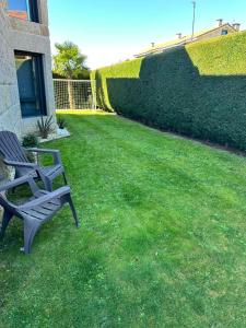 a bench sitting on the grass in a yard at La Villa Allariz in Allariz