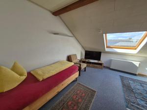 a room with a bed and a desk and a window at Unterkunft Julian in Waghäusel