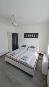 a bedroom with a large bed in a room at Grey Harmony Apartman in Debrecen