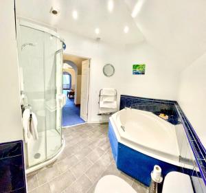 a large bathroom with a tub and a shower at Falls of Lora Hotel in Oban +85 photos