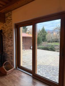 a sliding glass door with a view of a patio at Slnečný domček Sučany in Sučany