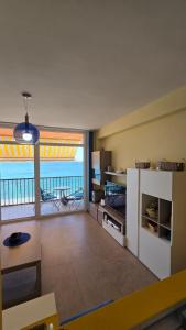 a living room with a view of the ocean at Primera Linea de playa in Almería