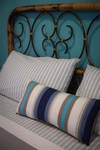 a bed with two pillows and a iron head board at Antonia's Home - casa per le vacanze con giardino e veranda attrezzati in San Domino +125 photos