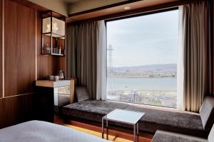 a hotel room with a large window with a view at Candeo Hotels Nankai Wakayama in Wakayama