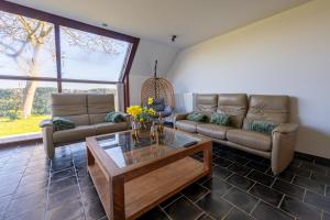 a living room with two couches and a coffee table at t' Zwaluwnestje in Zedelgem +33 photos