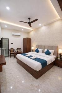 a bedroom with a large bed with blue pillows at The Vedam Hotels - Ram Mandir Ayodhya A unit of RL Group of Hotels Ayodhya in Ayodhya