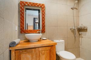 a bathroom with a sink and a toilet and a mirror at Meliora bali villa in Ubud +40 photos