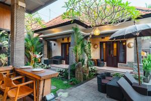a patio of a house with a table and chairs at Meliora bali villa in Ubud