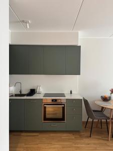 a kitchen with green cabinets and a table at Loo Apartment in Loo