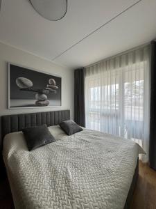 a bedroom with a bed and a large window at Loo Apartment in Loo +7 photos