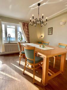 a dining room with a wooden table and chairs at Exklusive Ferienwohnung Strohberg in Plön +60 photos