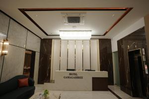 a view of a lobby with a table in a room at Gamagashree Hotel and Fine Dine in Sāgar
