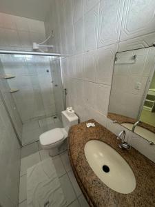 a bathroom with a sink and a toilet at Pousada Tambaú in São Luís +40 photos