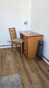 a desk with a chair in a room with a lamp at Snowdonia Mountain Lodge in Bethesda